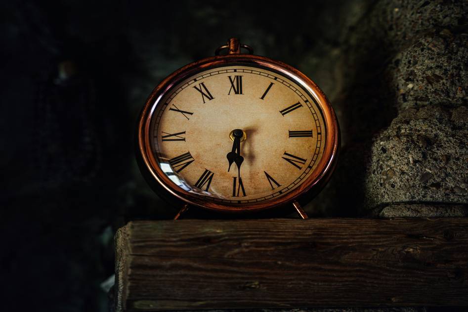 Close-up of ornate clock face and carved wood details